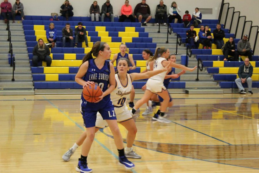 Baylie+Parks%2C+member+of+the+girls+varsity+basketball+team%2C+defending+the+ball.+