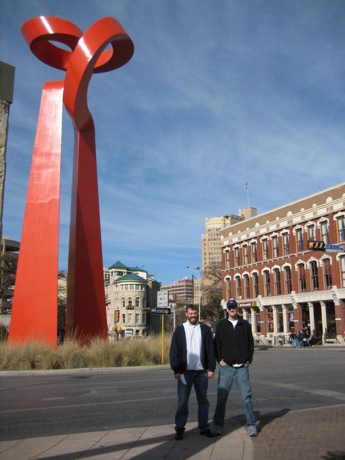 Joe May, English teacher, and David Voss, History teacher, standing in front of La Antorcha de la Amistad (The Torch of Friendship). The duo have been close friends for about 15 years have have participated in engaging Charity Bash events that showcased their close friendship.
