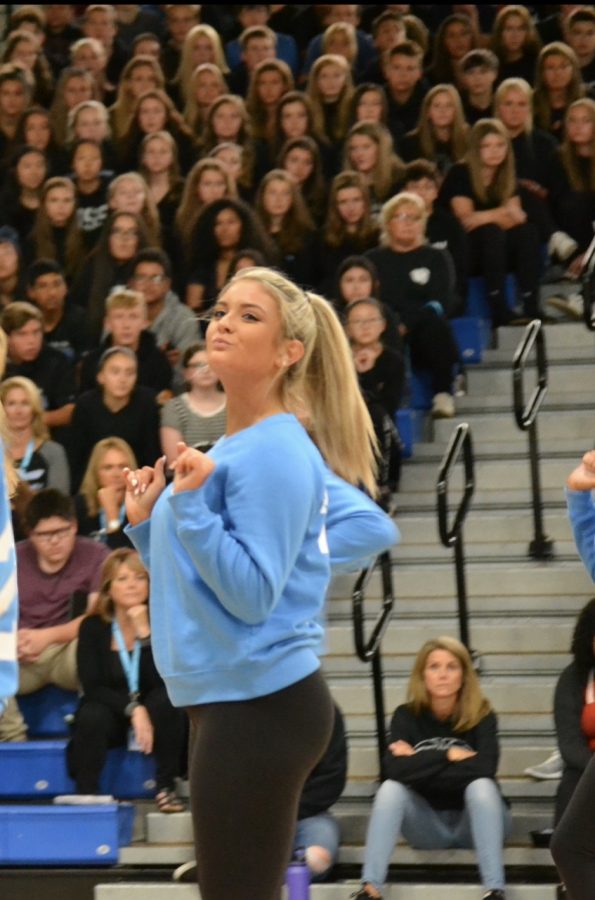 Nicole Albright, junior, dances at the 2019 homecoming assembly. She says she has developed a bond with her Poms team through dance.