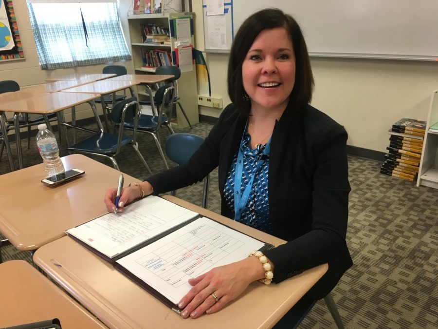 Erin DeLuga, future principal of LZ, smiling up from her binder. Although her job starts in July, DeLuga says she is already looking forward to joining the LZ family. 