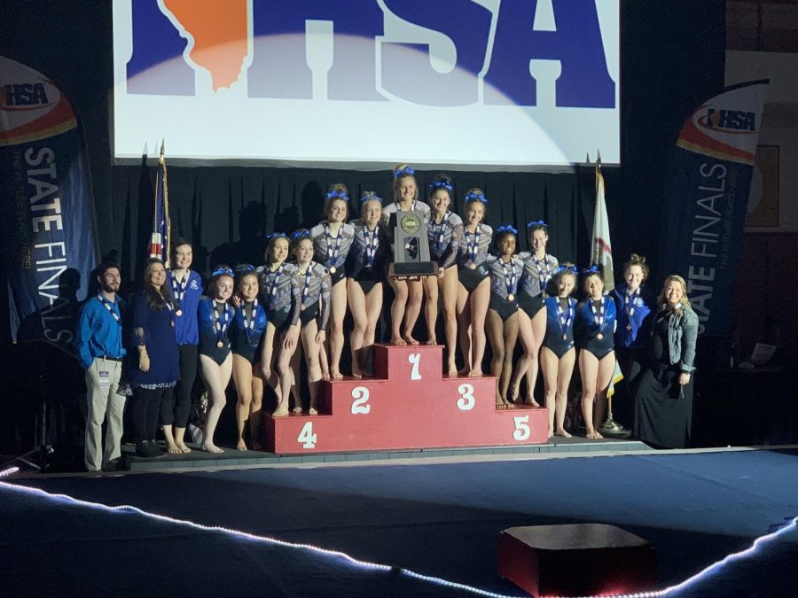 The+gymnastics+team+poses+with+their+trophy+at+State.+I+definitely+think+anyone+whos+done+gymnastics+for+a+long+time+is+never+going+to+get+out+of+it+completely%2C+Julia+Mcdevitt%2C+senior+co-captain%2C+said.+In+college+I+dont+think+Ill+be+doing+anything%2C+but+I+definitely+plan+on+a+summer+job+coaching+and+Ill+be+back+at+the+gym+all+the+time+to+visit.+I+still+have+a+lot+of+friends+that+arent+graduated+yet%2C+so+I+think+Ill+never+really+leave+the+sport.%E2%80%9D