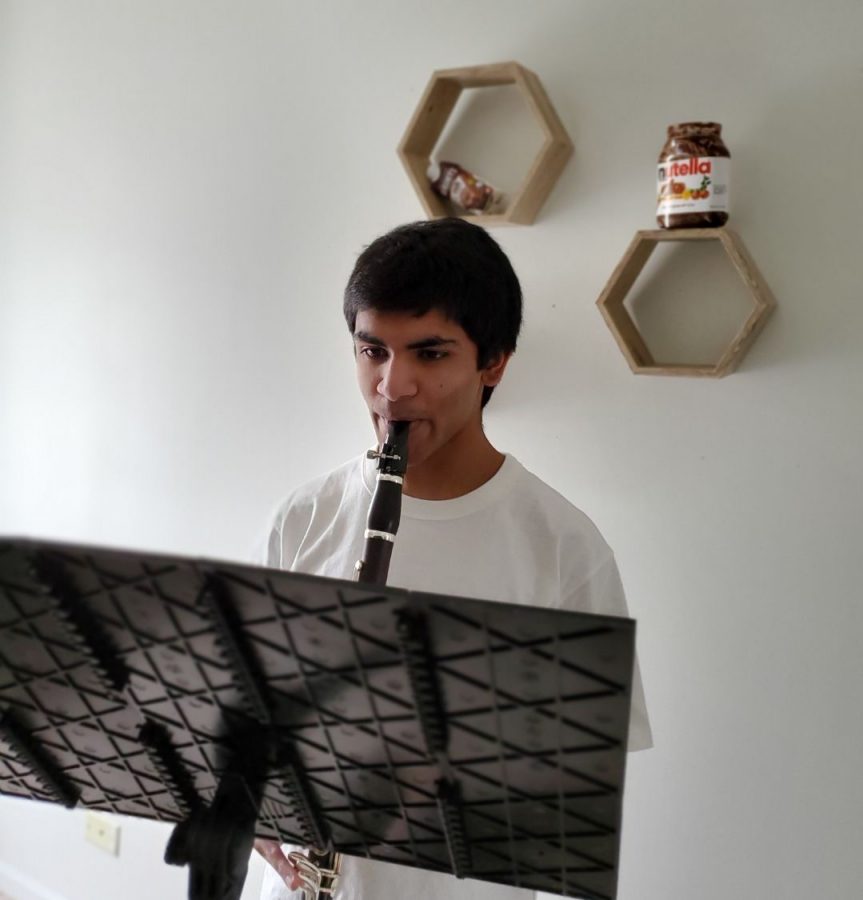 Jawad+Alam%2C+senior%2C+practicing+a+clarinet+piece.+For+him%2C+the+cancellation+of+his+final+high+school+musical+performances+was+disappointing.