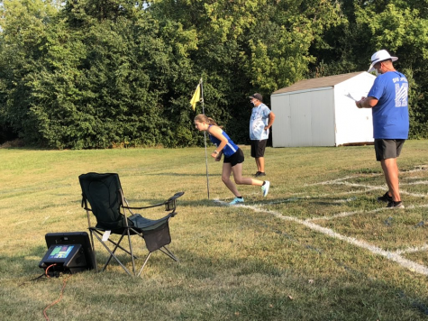 A Girls Cross Country team member gets set to start her race at a meet in the backfield of the school. Each runner starts the race individually this year as a result of COVID-19 and then the teams compare times at the end to determine the winner.