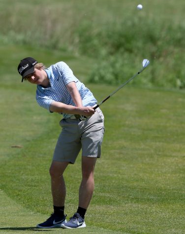 Brandon Koester, senior, hits a pitch in his approach shot towards the green. For him, the extension of his postseason has given him his first chance to play at a sectionals tournament. 
