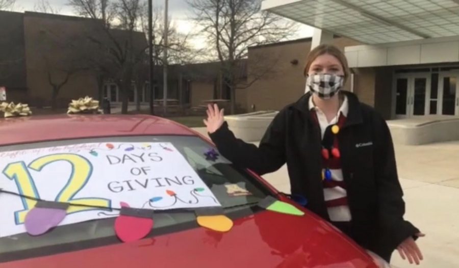 Ashley DeLuga, junior Student Council Executive Officer, explains the car decoration contest occuring during the 12 Days of Giving, which students can participate while  dropping off their donations at school.