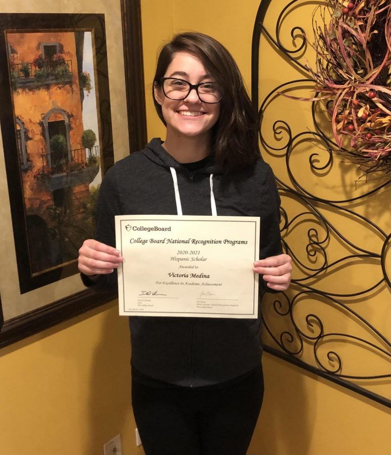 Tori Medina, senior, holds up her National Hispanic Scholarship award certificate. Medina says the award was especially significant to her because it allowed her to connect to her Hispanic heritage.