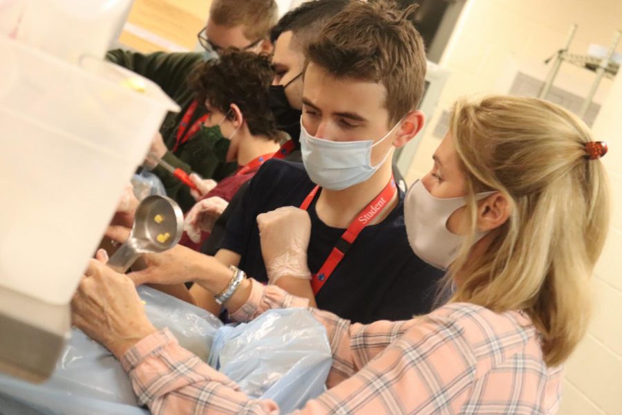 Transition students help out with portioning. When the pandemic hit and the district expanded their free meals program, the Transition students jumped in to help prepare extra meals for kids in need. 