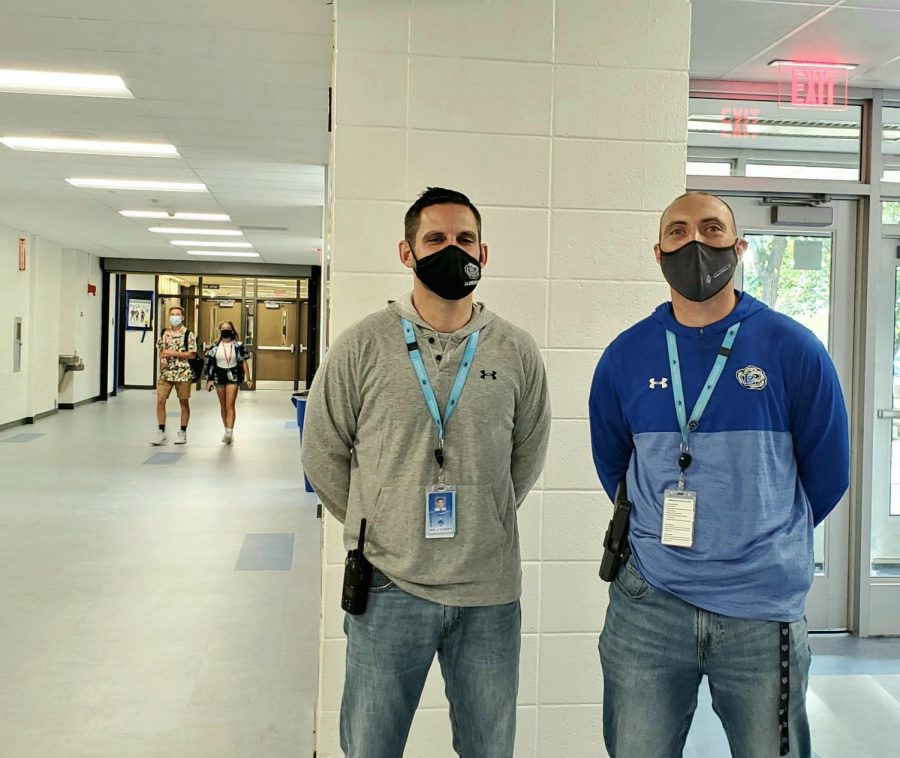 Mark Frey, school resource officer, stands with Matt Aiello, dean of students, across from the main office, where they normally greet students. “He listens, he doesnt lecture. He is there to listen and he will offer advice. Hes at all the events and hes there as a person who wants to be there; hes got no other agenda,” Aiello said. “He wants to be there for the students, he wants to be there for the staff. He can take a joke and he can give a joke. I think just his demeanor, you see him and I often in the halls and we try to say hi to everybody. He tries to say ‘hi’ to everyone and jokes with everybody. I think he brings a really calming presence to our building.”