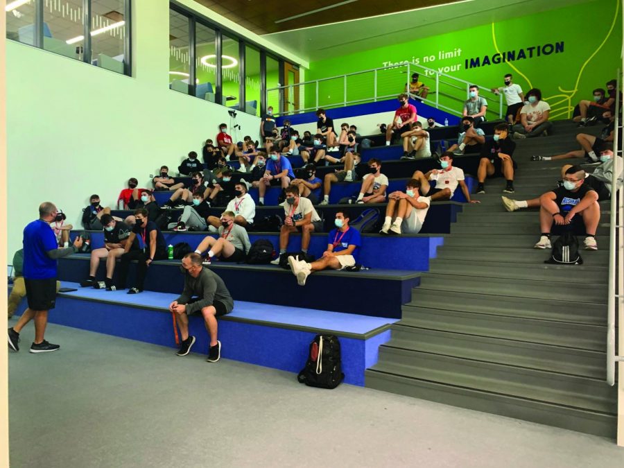 Pictured here are students utilizing the spaces during the school day, including before and after school. They use the brand new library and learning stairs to work collabortively together or simply getting their homework done. The library and steam room also feature new furniture and meeting rooms for students as well. Pictured above the football team uses the learning stairs to go over different strategies. 