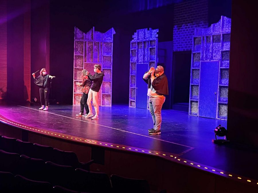 Actors practice performing the upcoming play Puffs on stage. 