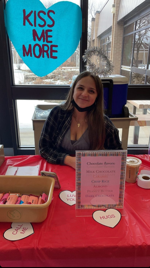 Katie Zigic, sophomore, sells Cupidgrams for Student Council in the cafeteria.