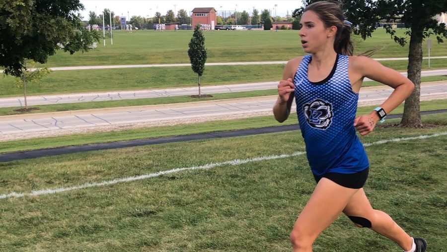 Brooke Johnston, senior, runs at a Girls Track and Field meet. Along with track, Brooke is dedicated to other extracurriculars, such as Bear Voices and Cross Country.