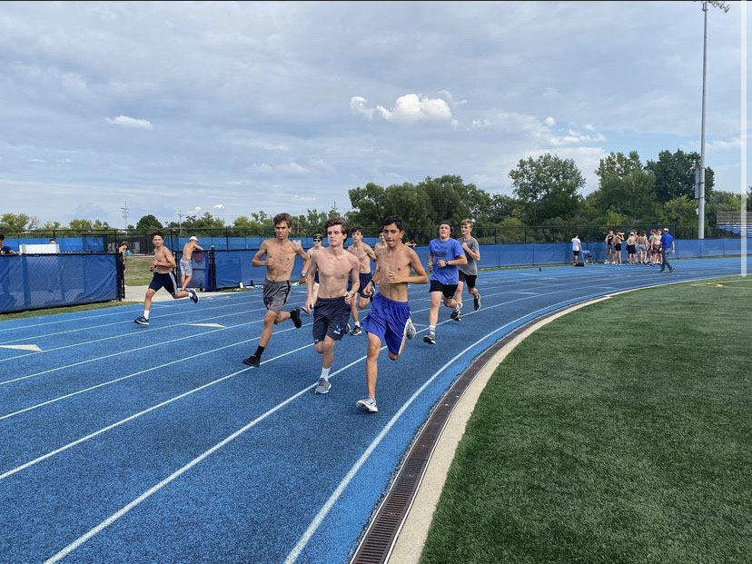 Boys cross country runs during practice preparing for the season at summer camp. 