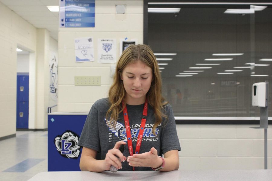 Zoe Pavlu, senior, uses anti-bacterial spray.