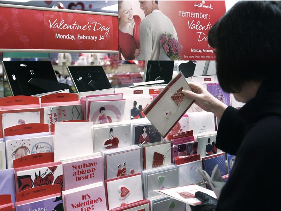 Women deciding which Valentines Day card to get for a significant other or friend of hers.