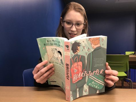 Annie Moriarity, junior, reading the graphic novel Heartstopper. Heartstopper is widely loved in the LQBTQ+ community, and showcases the love between two teenage boys and the struggles they undergo.