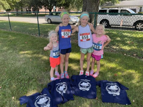 Stanton’s four daughters smile and pose together as they get ready to run a 5k in their town.