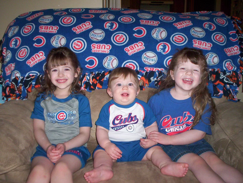 McHugh sits on a sofa with her siblings. McHugh has an older sister and a younger brother, and believes she has a strong relationship with both.