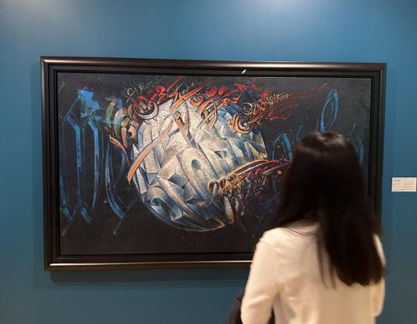 A junior Spanish student observes a painting at the museum. With the trip being largely self-paced, students could  stop and spend time looking at works that intrigued them.