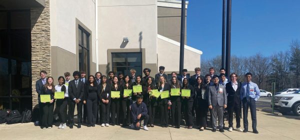 Students pose in front of the FBLA state competition in Springfield, Illinois on April 6. The students with the green certificates placed at the competition and seven of these students will compete at Nationals after qualifying in their respective events at state.