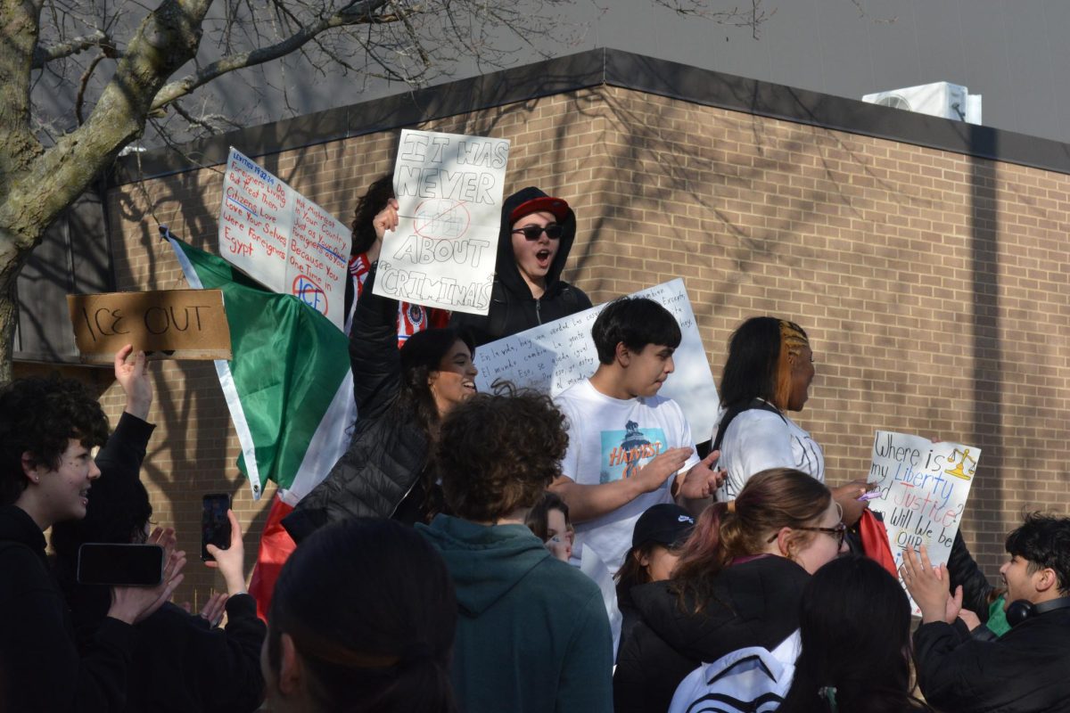 Students protesting during the walkout Saunders organized. They are reading out different posters to show their position against ICE.